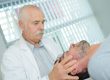 Chiropractor holding patient's head
